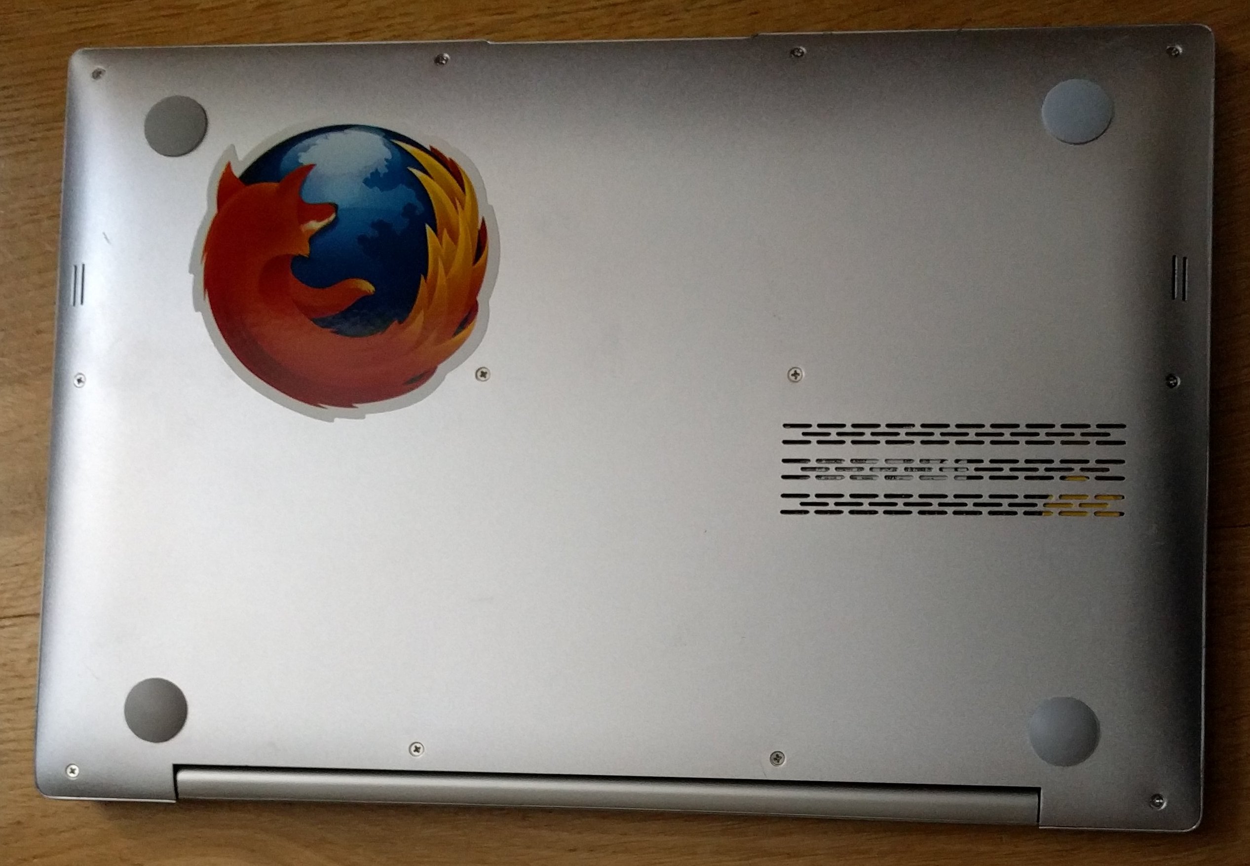 Back of the laptop with normal screws and it's first sticker.